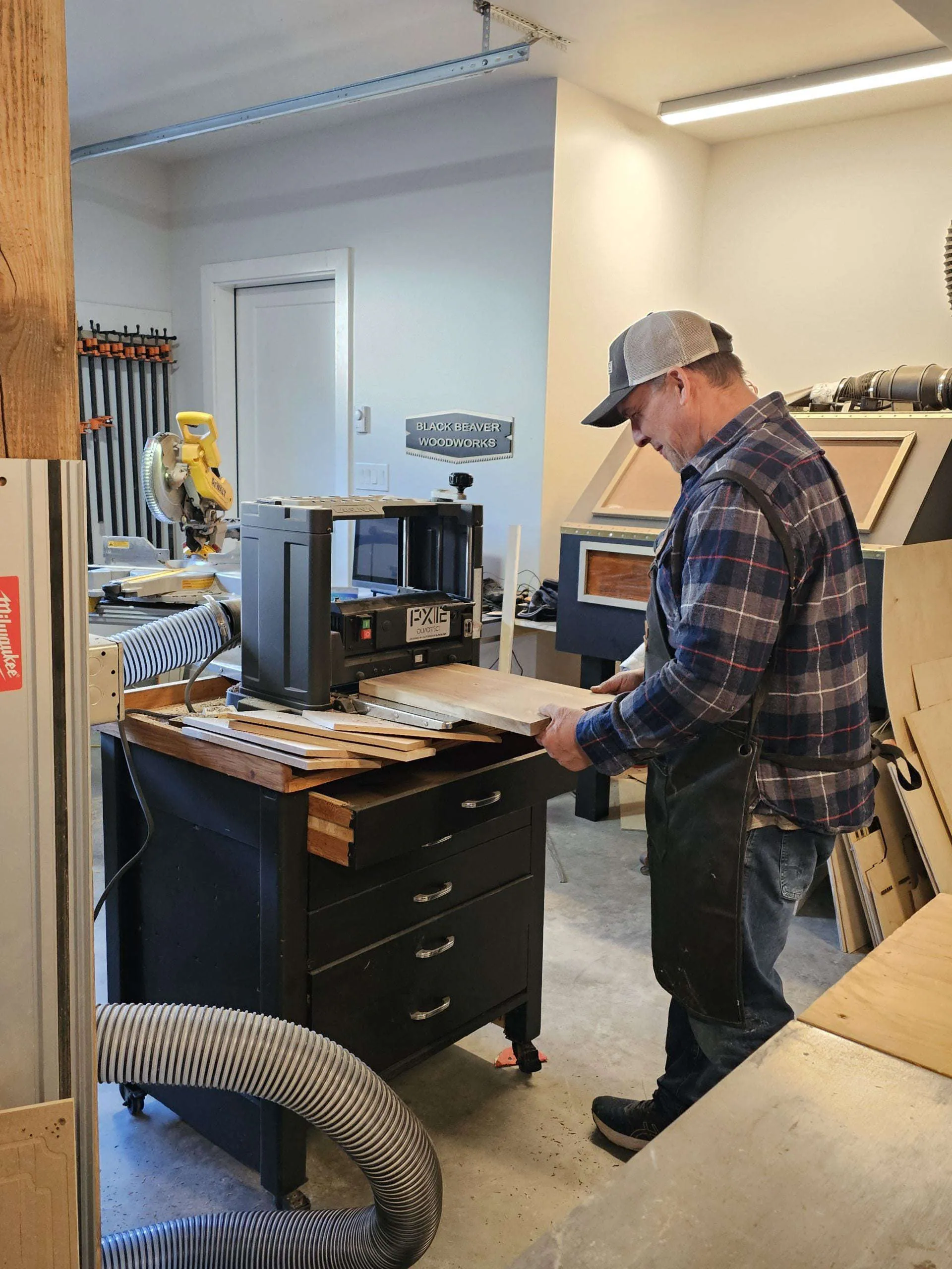 Our founder planing a hardwood board in the Black Beaver Woodworks workshop